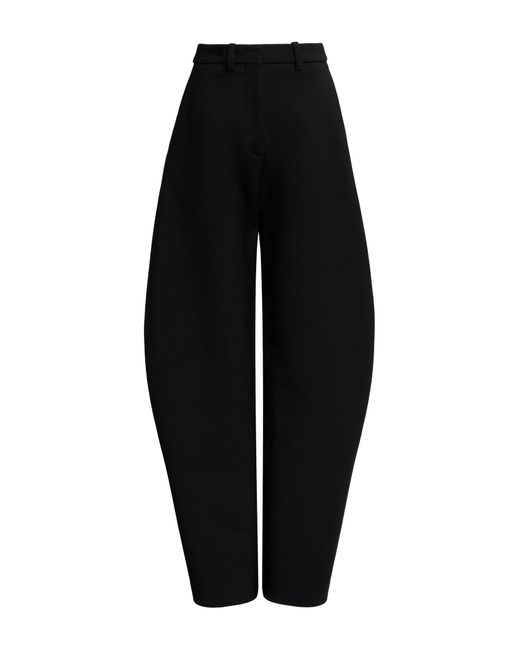 Pantaloni in lana arrotondati di Alaïa in Black