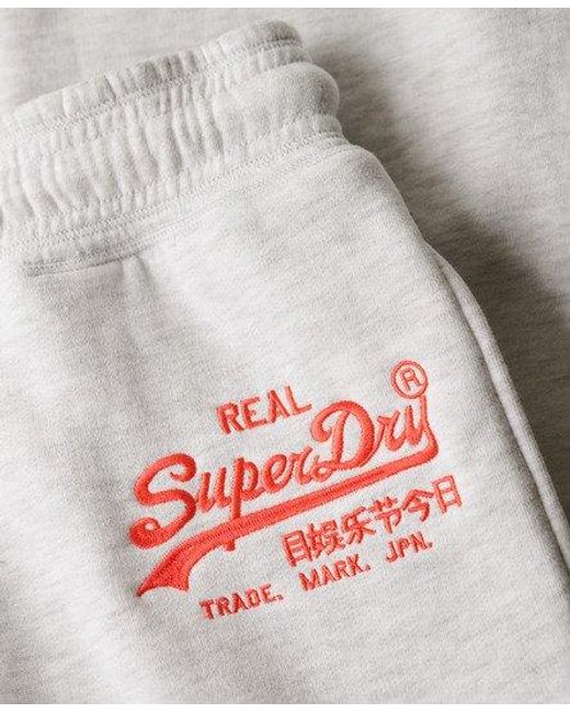 Pantalon de survêtement évasé taille basse vintage logo fluo Superdry en coloris White