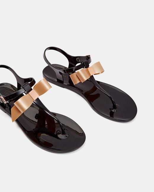 black jelly sandals with bow
