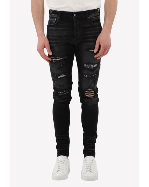 Amiri Denim Ripped Logo Patch Jeans in Black for Men | Lyst Canada