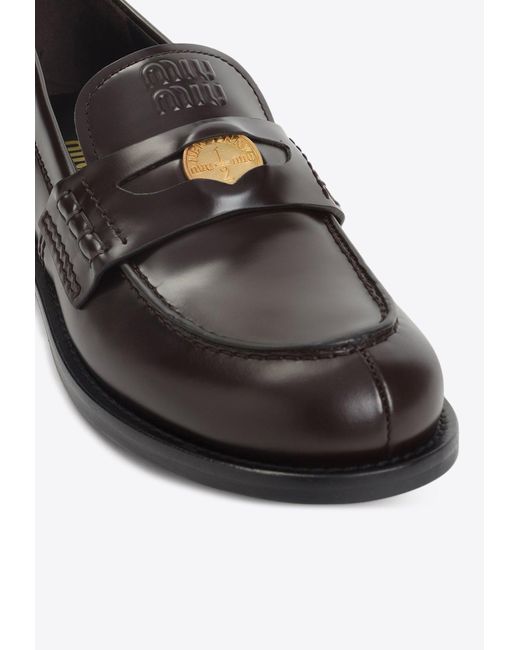 Miu Miu White Embossed Logo Penny Loafers