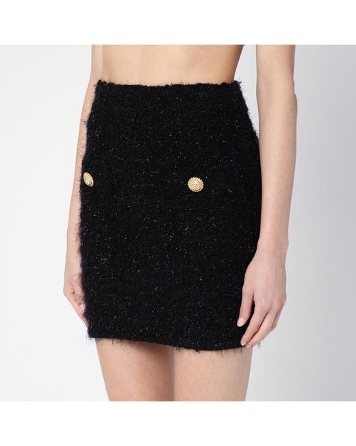 Minigonna nera in tweed con bottoni di Balmain in Black