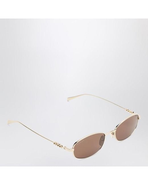 Occhiali da sole ovali oro/marroni di Gucci in Pink
