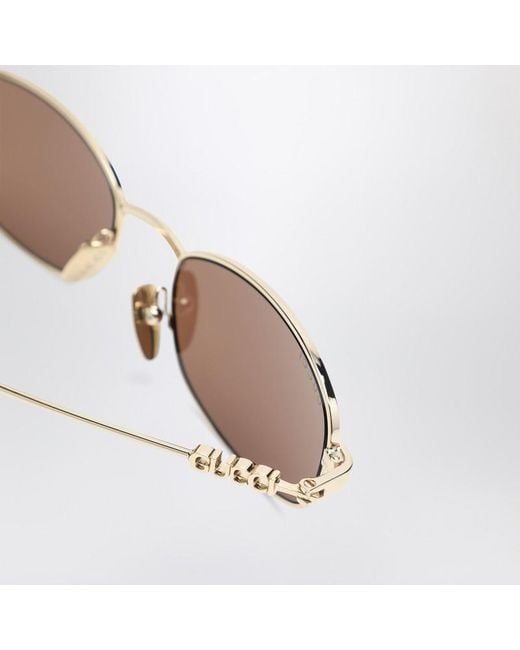 Occhiali da sole ovali oro/marroni di Gucci in Pink