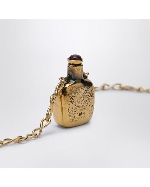 Collana con ciondolo elixir in ottone vintage gold di Chloé in White