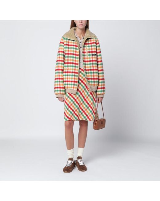 Gonna rossa/verde/soia in check e pile di Miu Miu in Orange