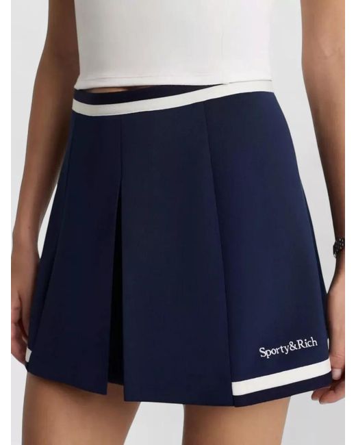Sporty & Rich Blue Mila Serif Logo Pleated Mini Shorts