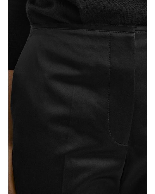 Totême  Black Kick Flare Raw-Edge Trousers