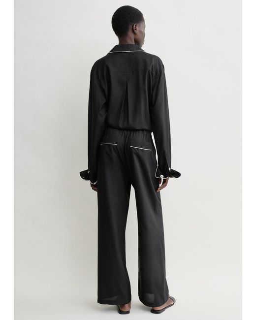 Totême Black Piped Silk Trousers