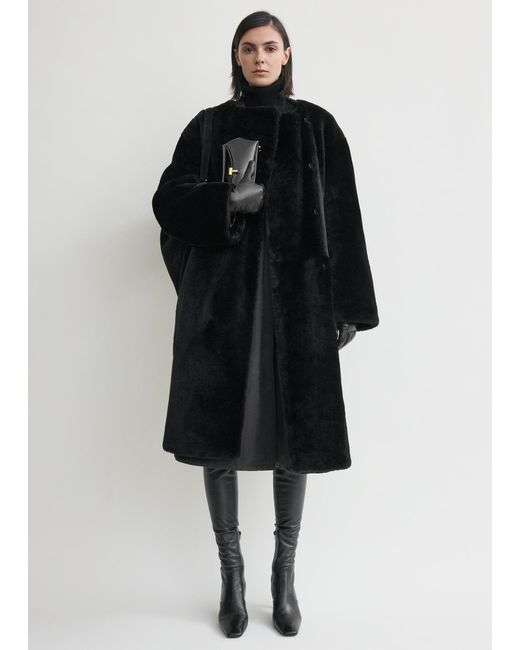 Totême Black Collarless Shearling Coat