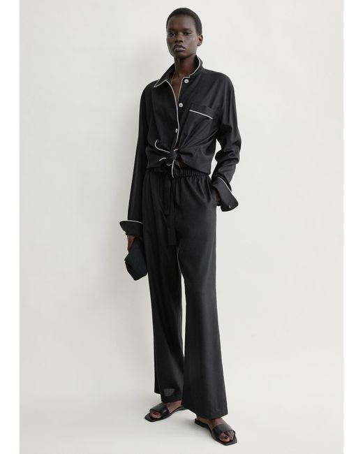 Totême Black Piped Silk Trousers