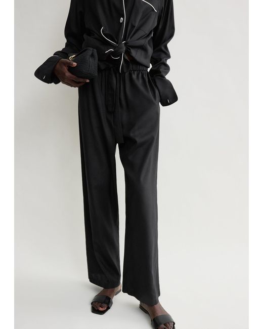 Totême Black Piped Silk Trousers