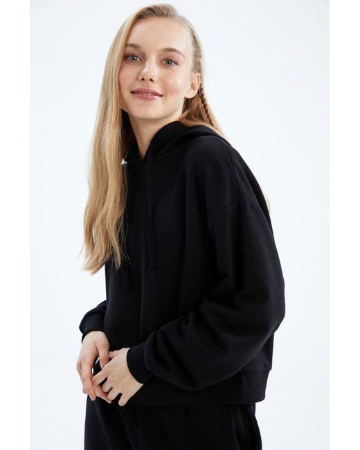 Defacto Black Cooles sweatshirt mit lockerer passform und kapuze