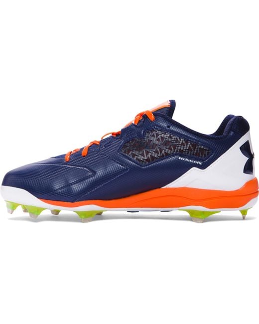 orange and black under armour baseball cleats