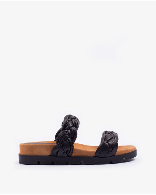 Sandales plates en cuir à lanières tressées Unisa en coloris Black