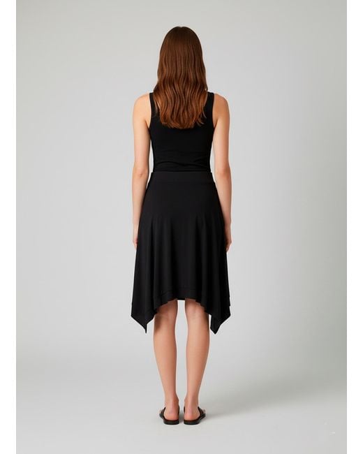Conquista Black Asymmetric Flared Skirt – Modern, Flowy, Effortlessly Versatile