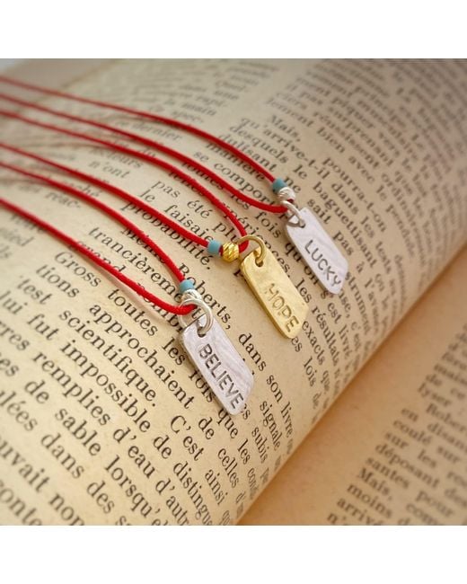 The Pheia Metallic String Believe Necklace