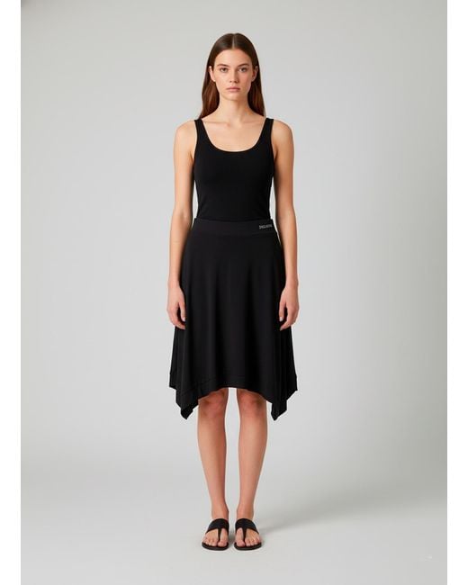 Conquista Black Asymmetric Flared Skirt – Modern, Flowy, Effortlessly Versatile