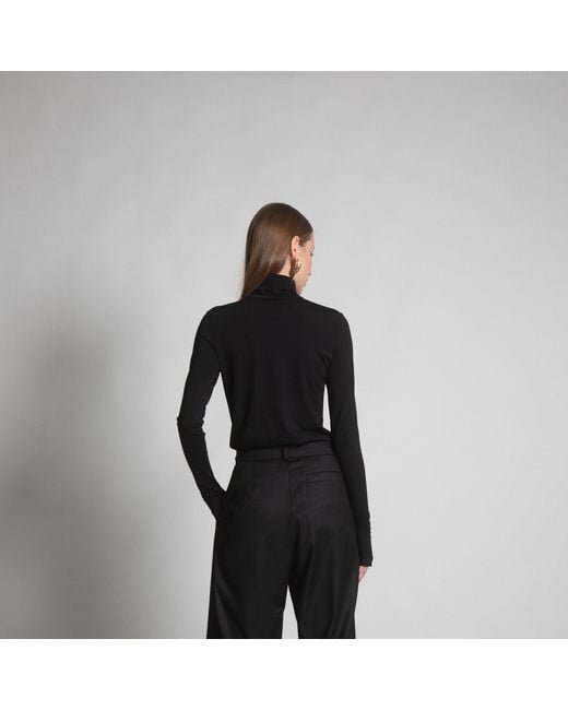 Una Berzina Black Turtleneck