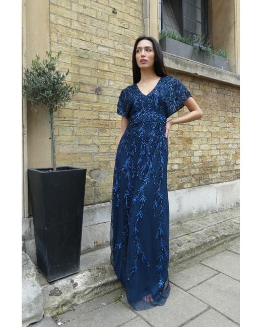 Raishma Blue Serenity A Flattering V Neckline, Tie Up Back, Cap Sleeve & All Over Hand Embellishments Gown