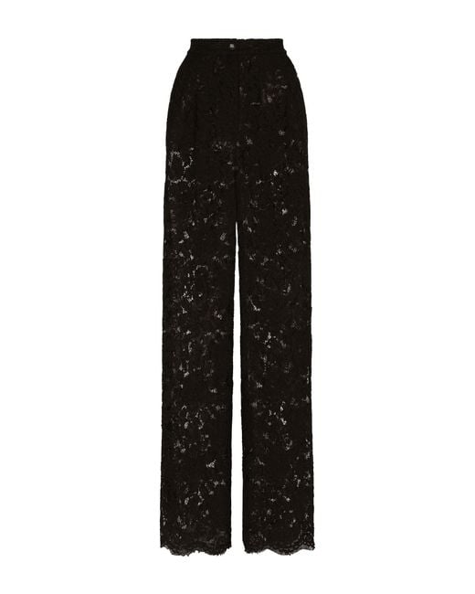 Pantalon flare en dentelle stretch à logo Dolce & Gabbana en coloris Black
