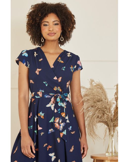 Yumi' Blue Butterfly Print Dip Hem Midi Wrap Dress