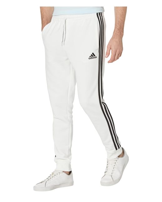 Adidas Essentials 3 Stripes Tapered Cuff Fleece Pants In White For Men