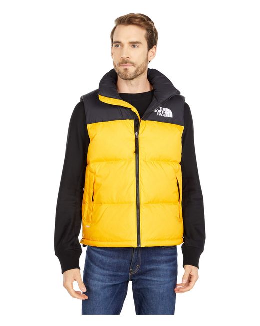 yellow and black north face puffer