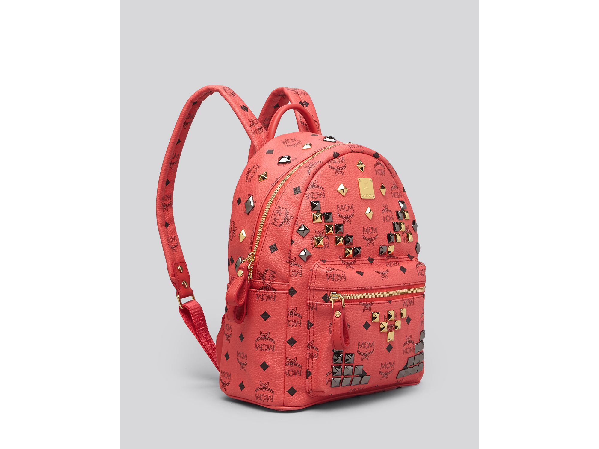 red mcm backpack with studs