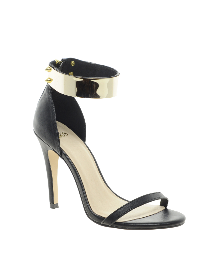 black sandals with gold trim