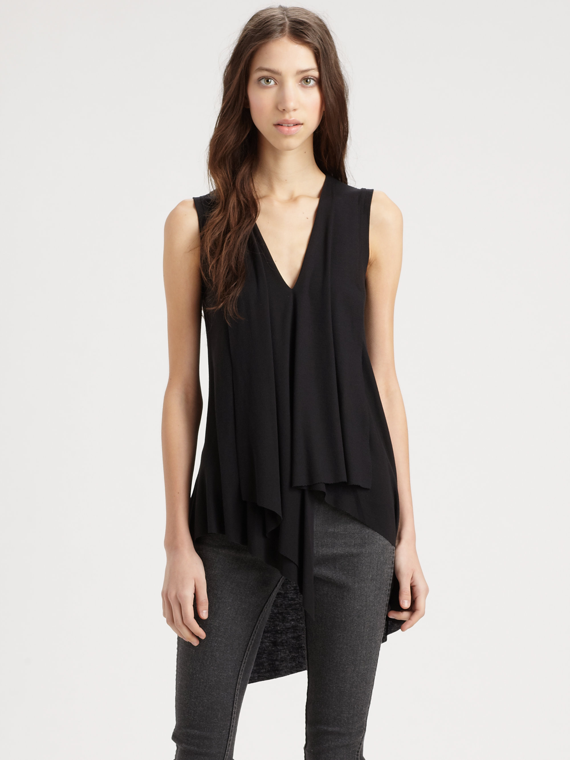 SIZE CHART(CM) This flattering and edgy asymmetric hem gives a soft basic tunic a not-so-basic silhouette. Crew neck Short sleeves Asymmetrical hem Knot accent CONTENT + CARE Rayon/spandex Wash cold; dry low Made in USA plus size tops SIZE + FIT Model is 5'9
