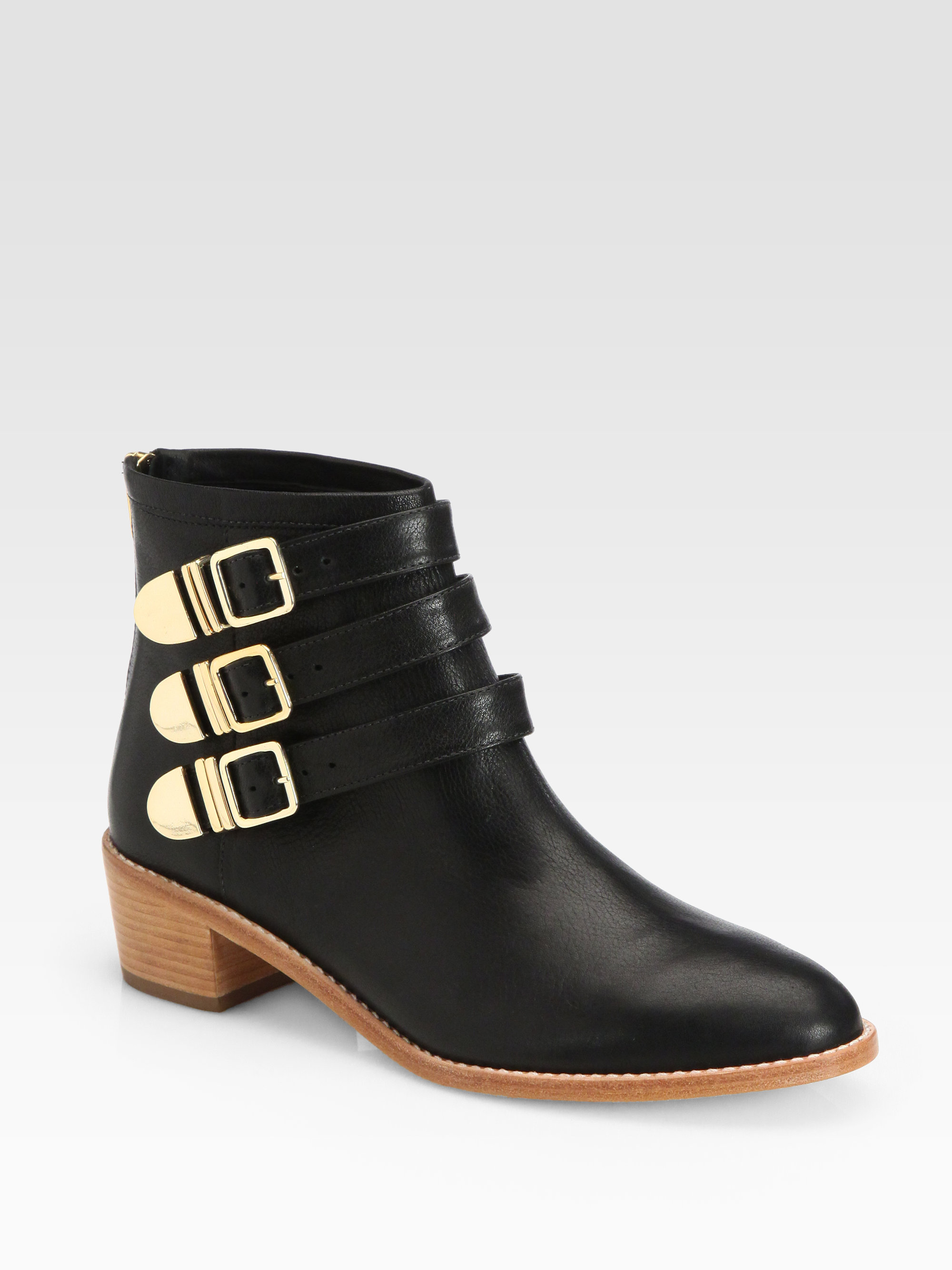 black ankle boots with gold buckles