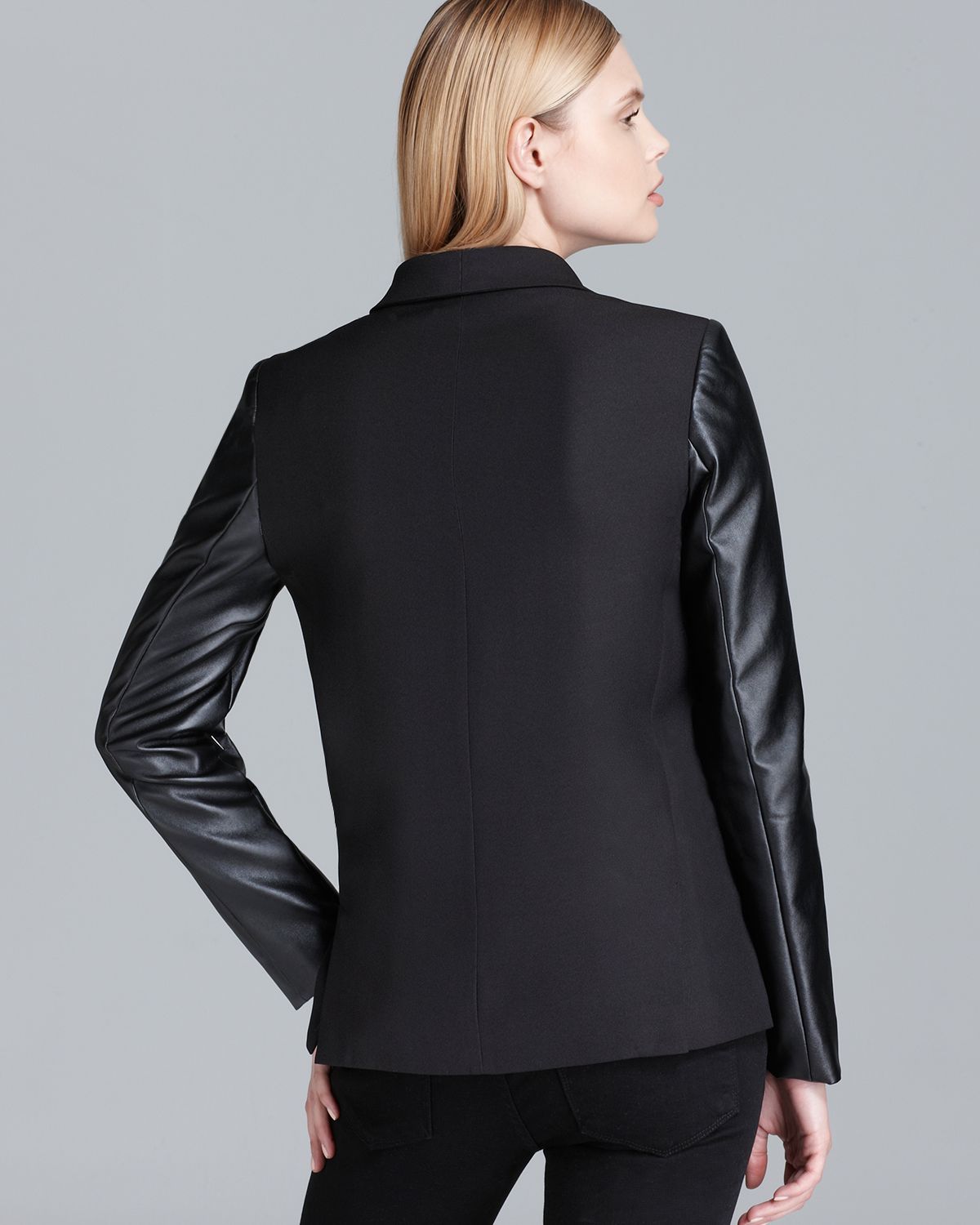 Blazer with faux leather sleeves Sleek faux-leather sleeves make this sophisticated Dkny jacket a modern statement-maker, whether paired with a skirt for the office or with denim on the weekend.