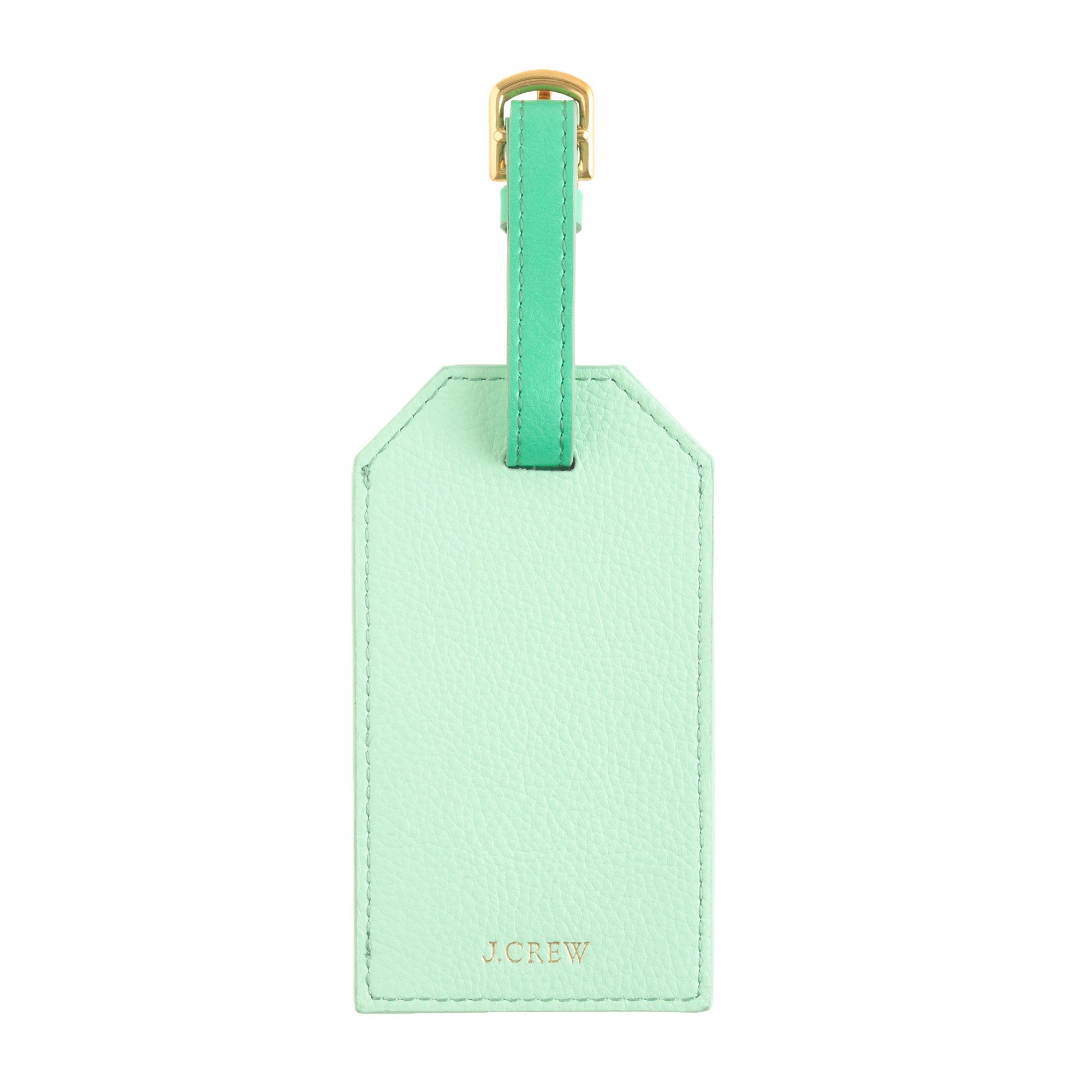 green luggage tags