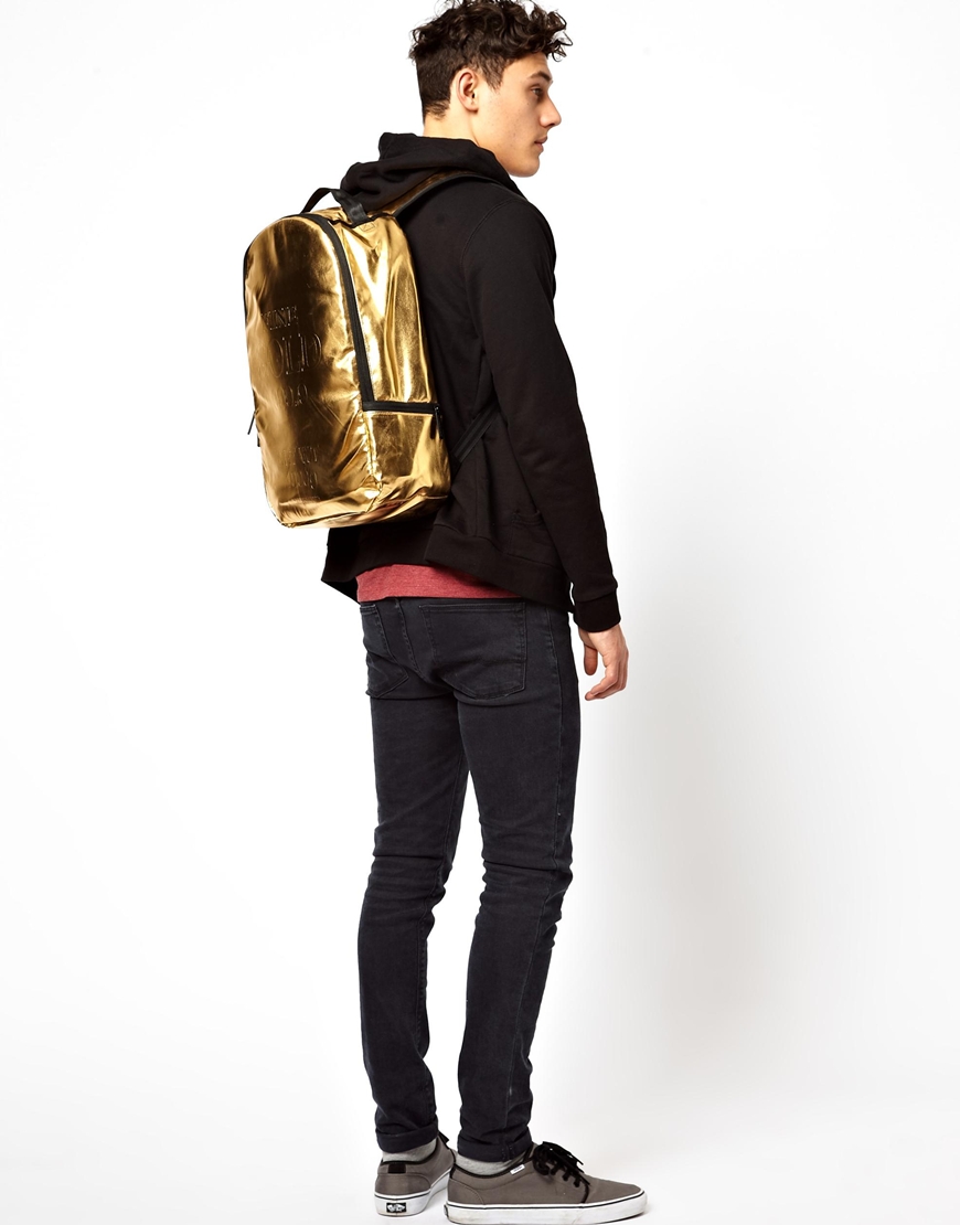 gold sprayground backpack