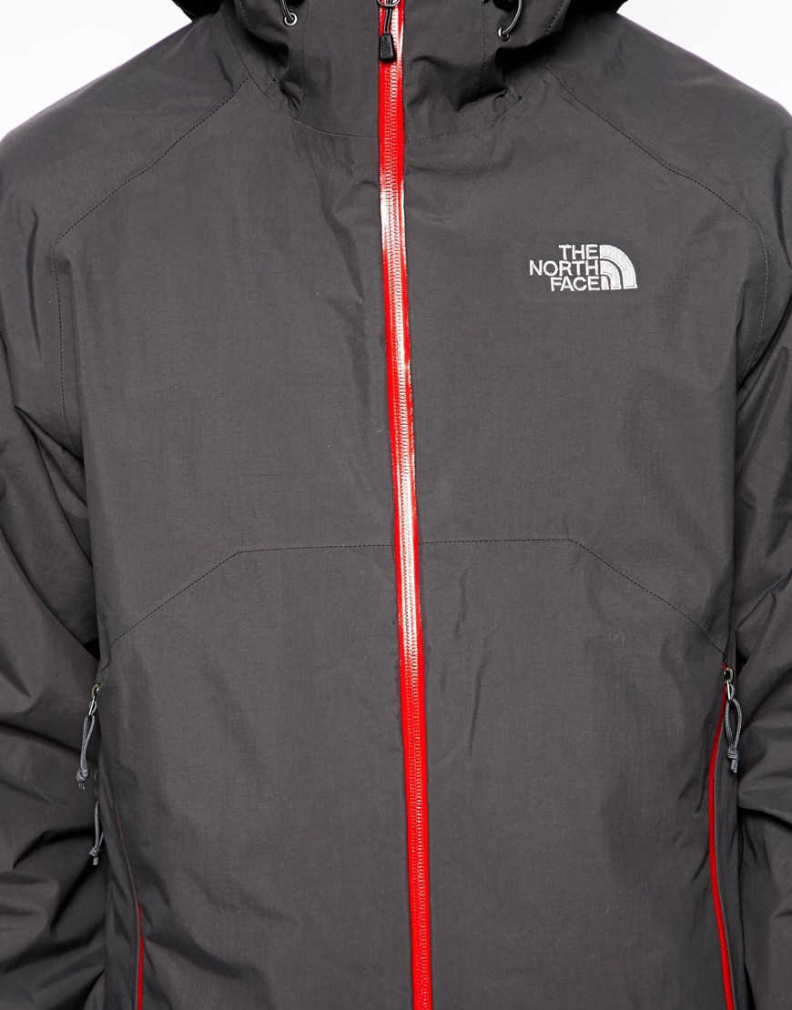 red and gray north face jacket