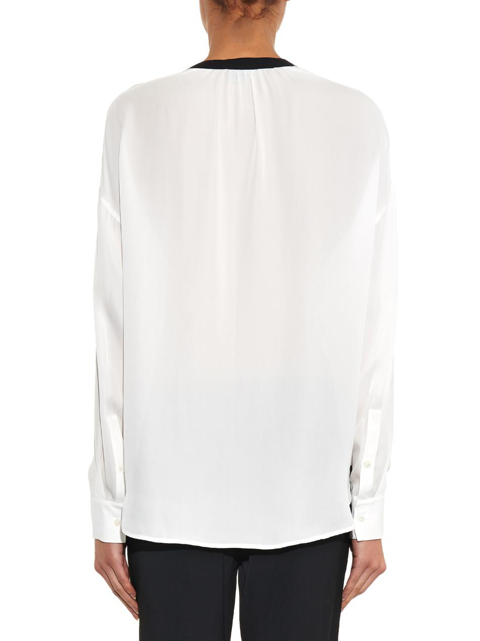 white silk blouse with black trim