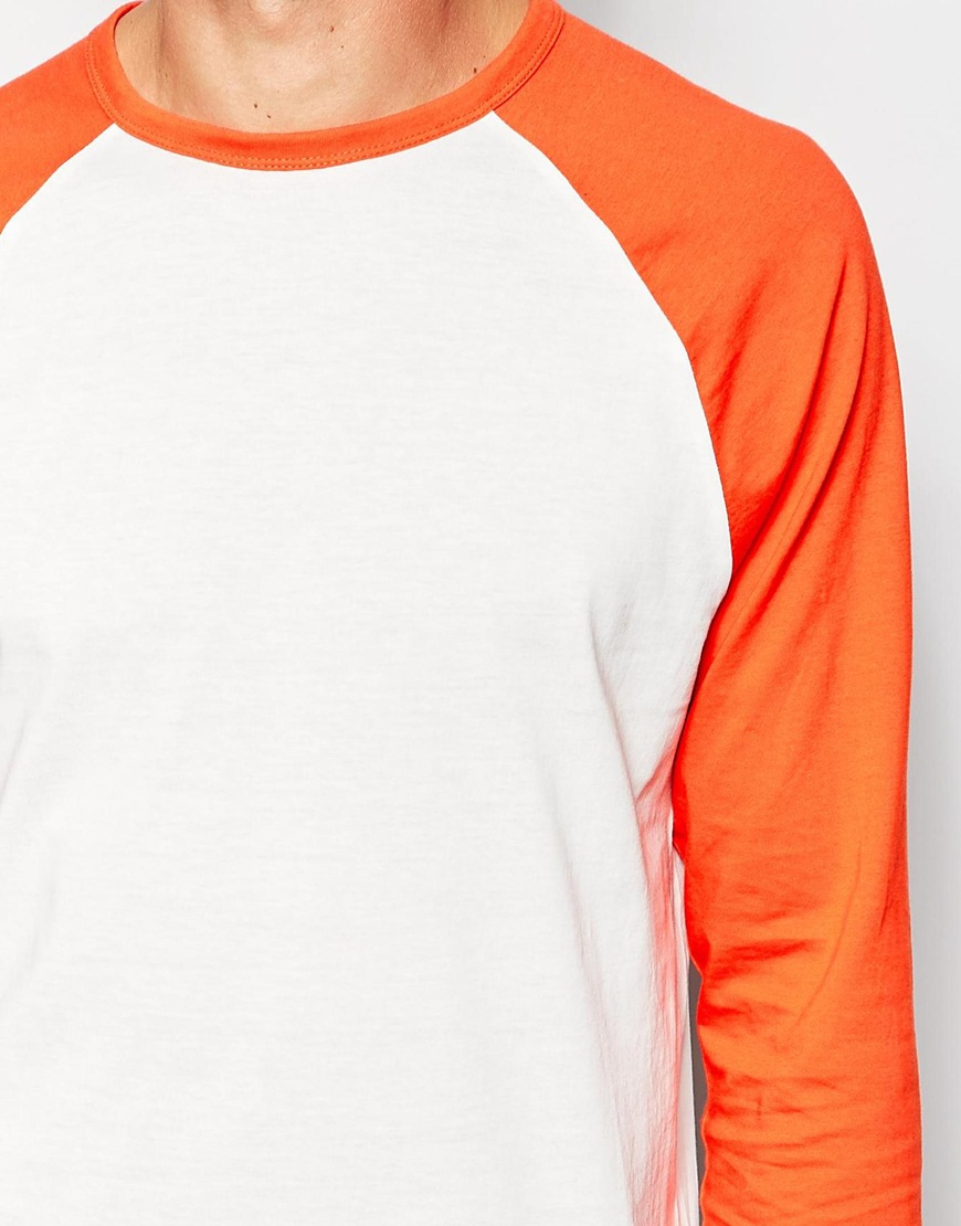 orange and white raglan shirt