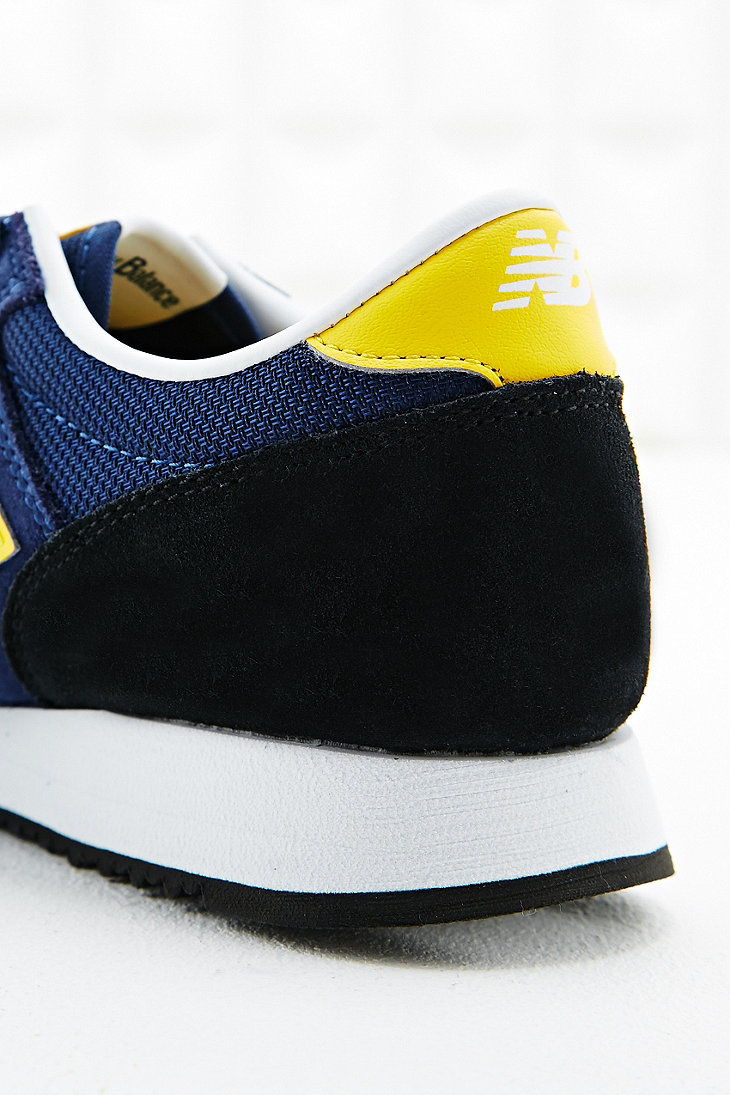 new balance 620 runner trainers in navy and yellow