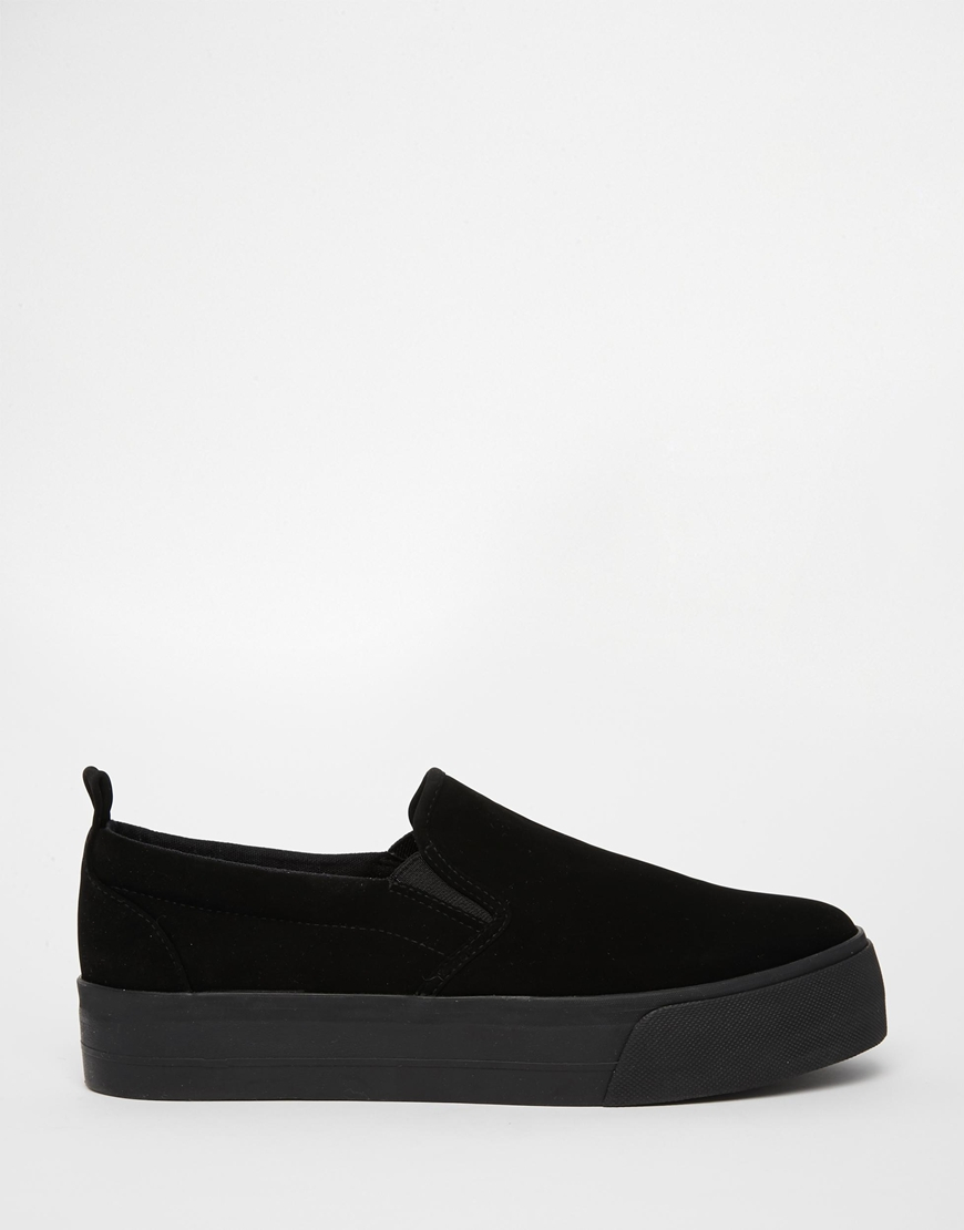 black sole slip on sneakers