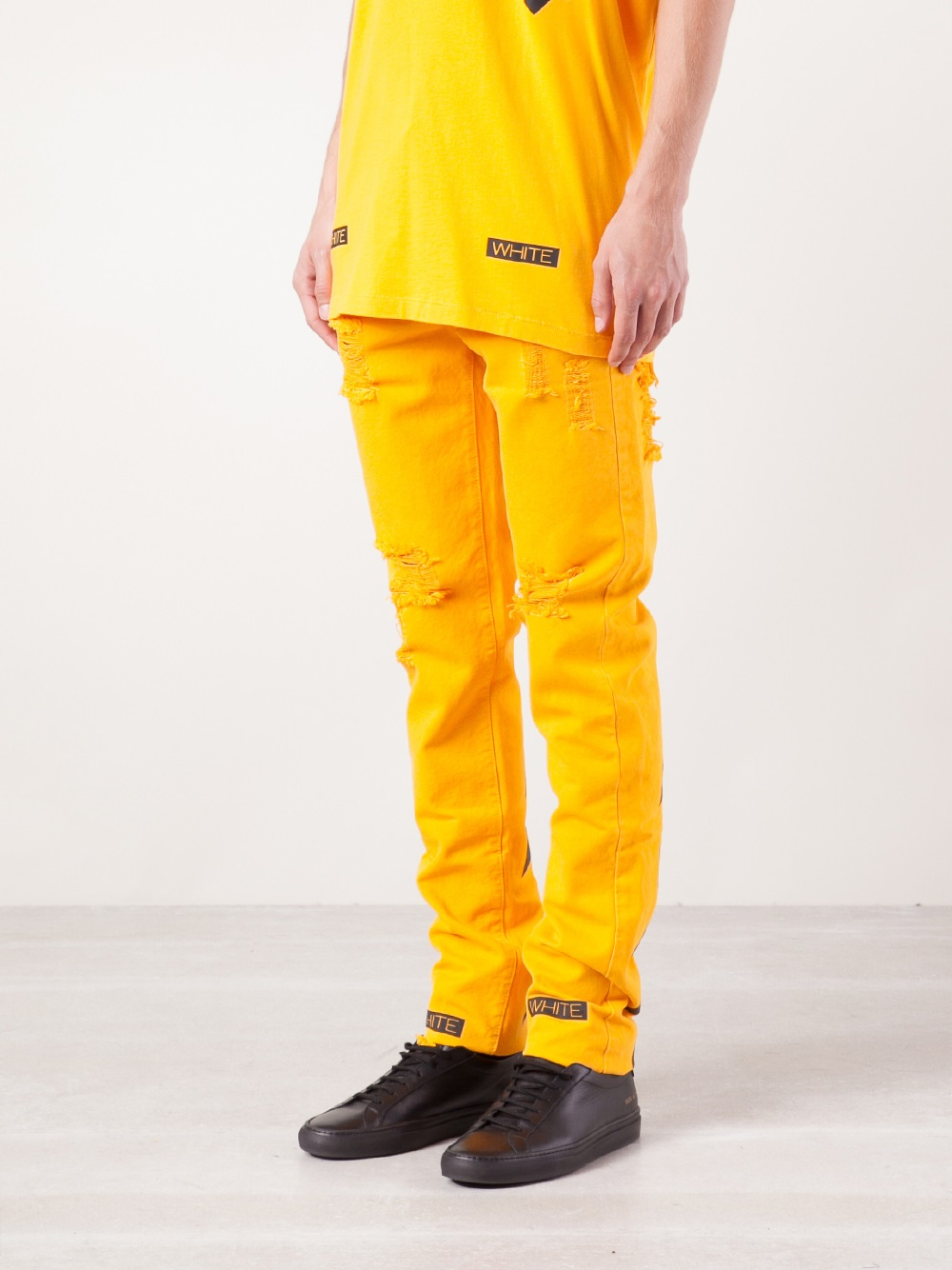 off white pants with yellow stripe
