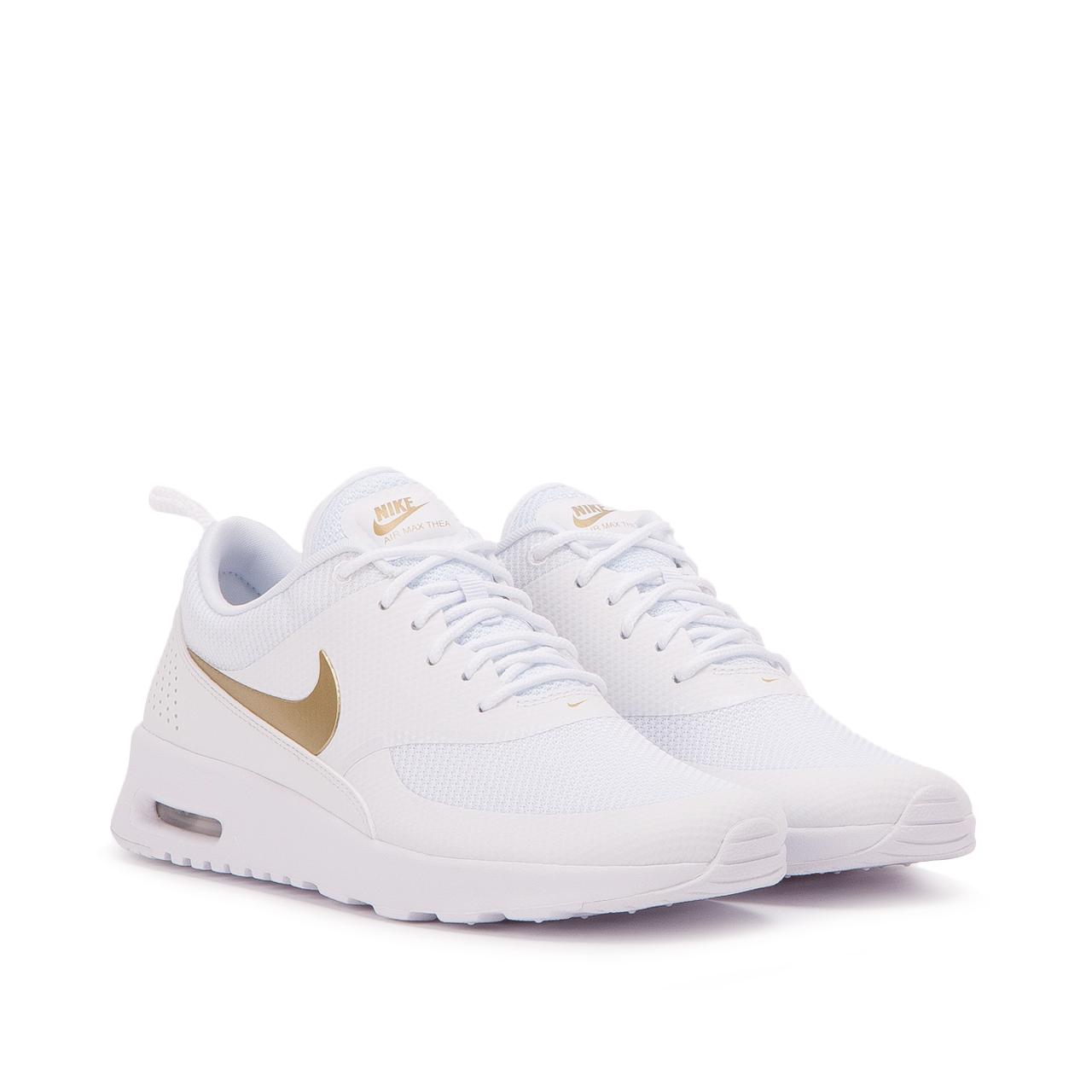 white and gold nike thea