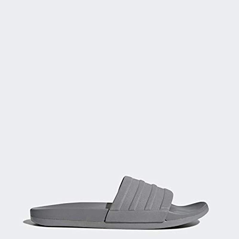 grey and white adidas slides