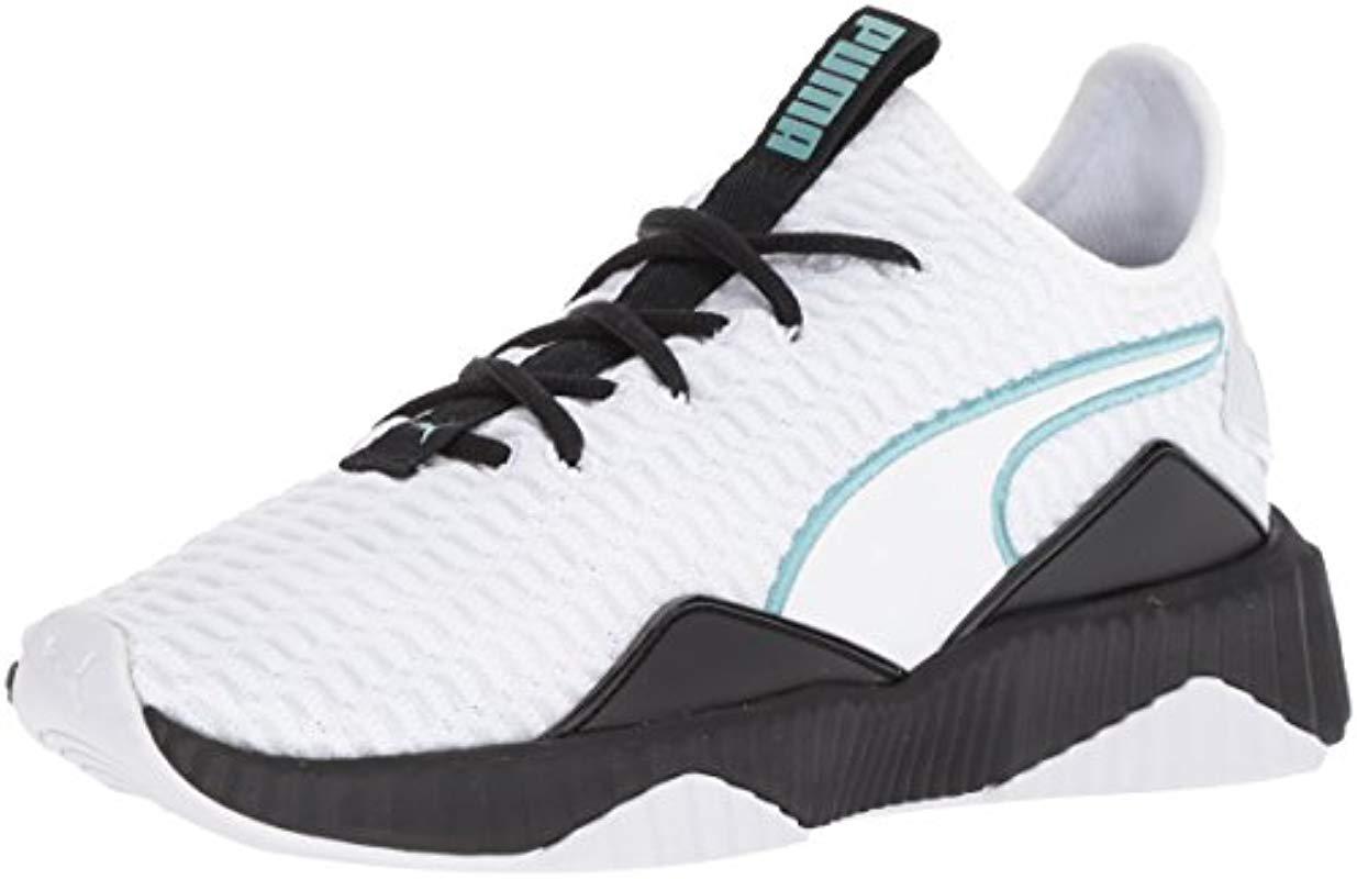 puma defy sneakers in white