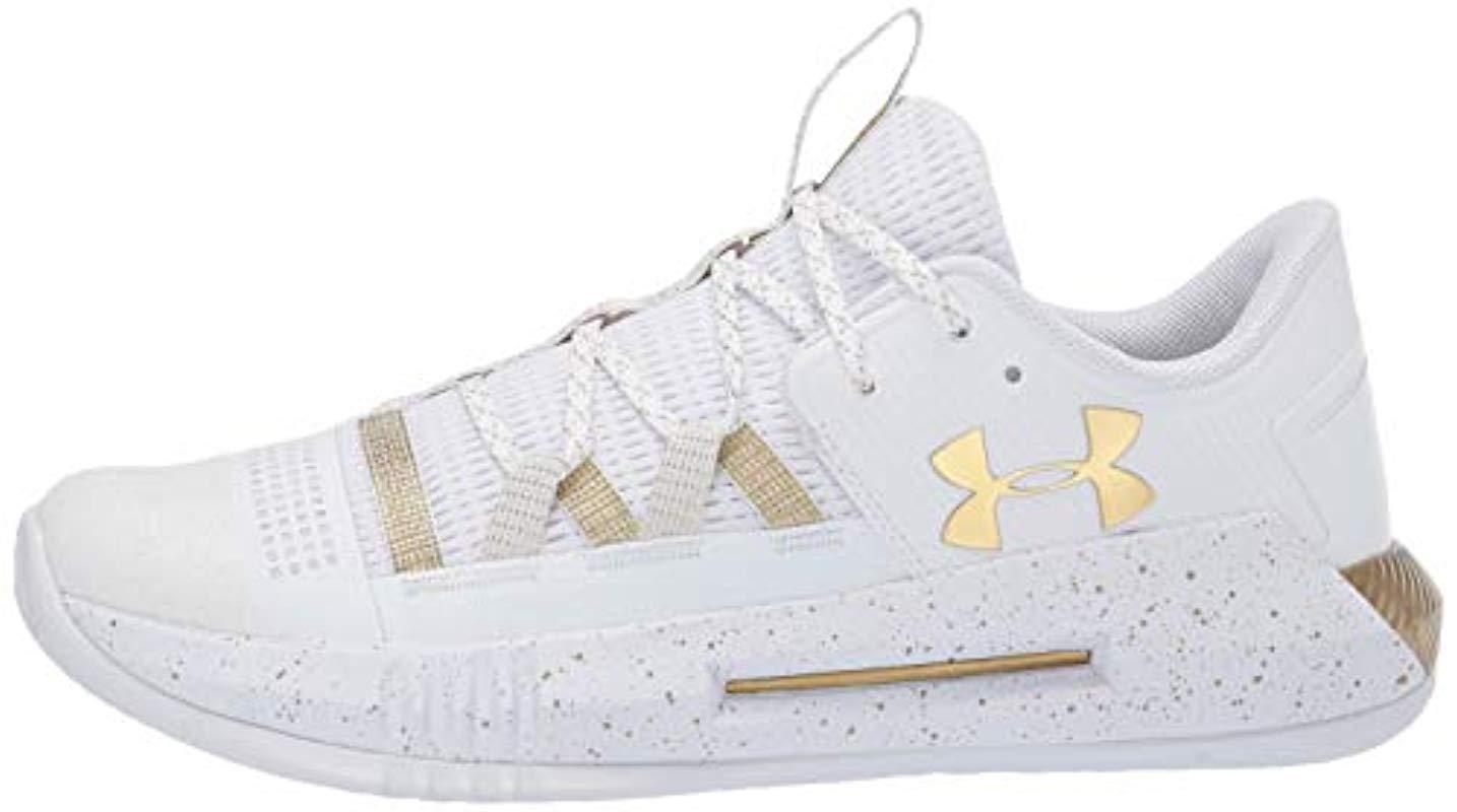white and gold under armour volleyball shoes