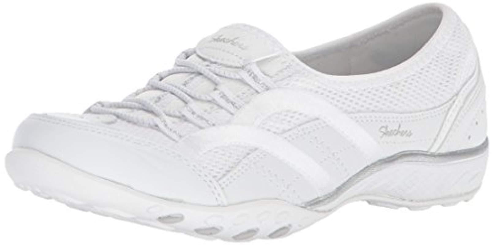 white skechers slip on trainers