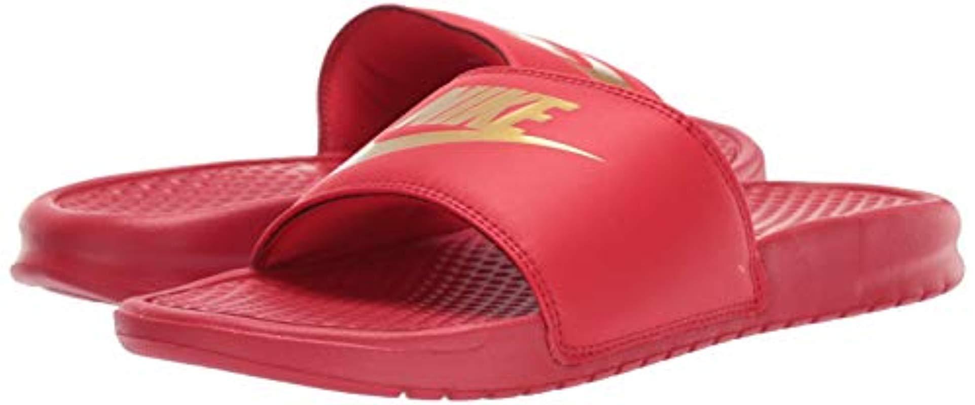 red and gold nike slides