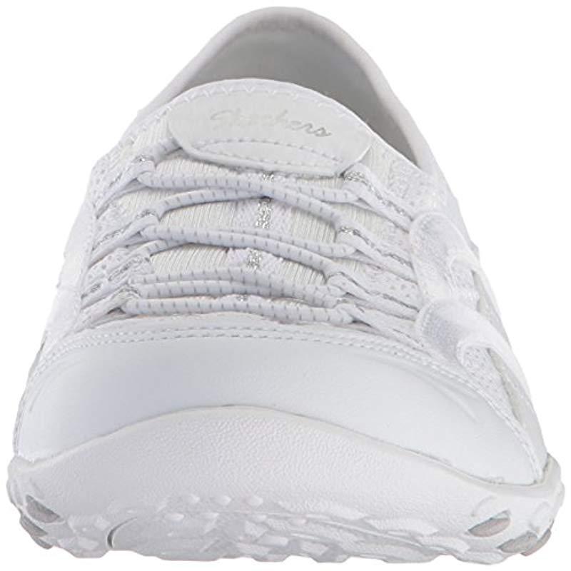 white skechers slip on trainers