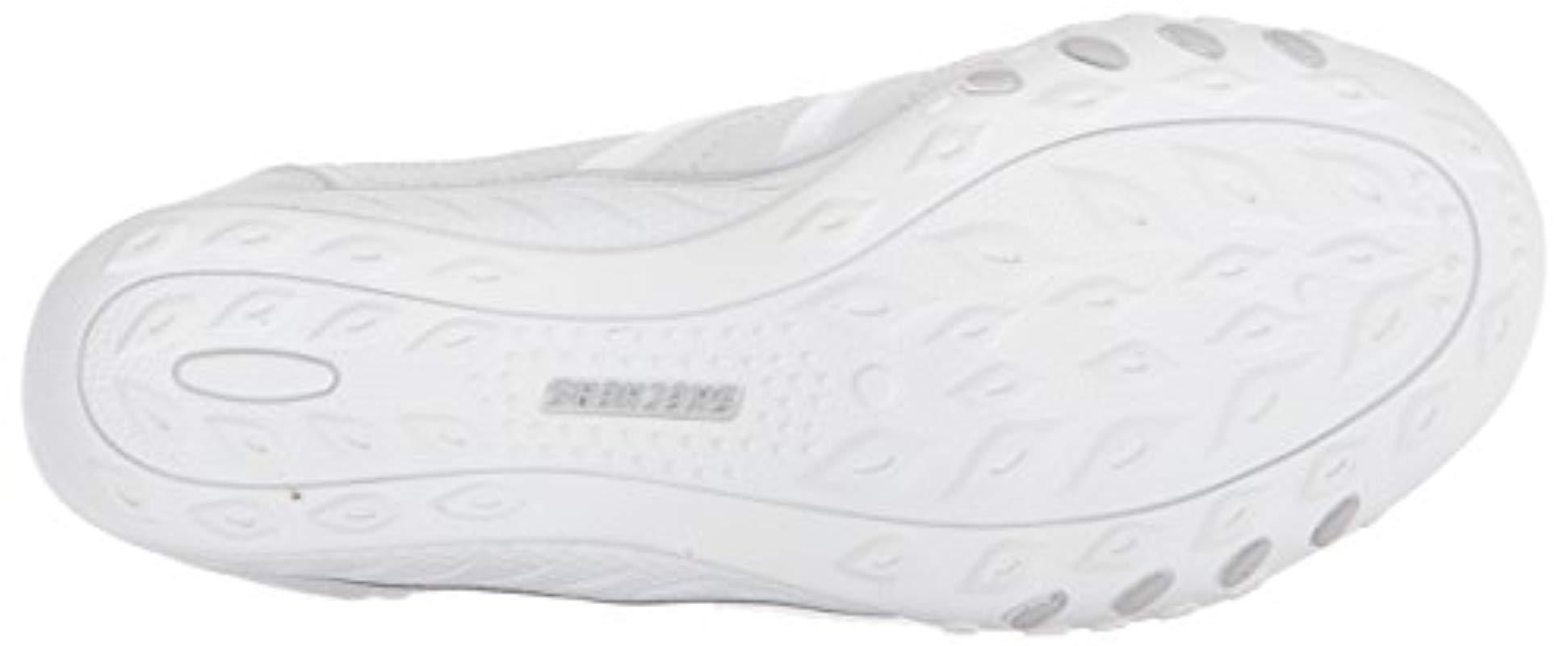white skechers slip on trainers