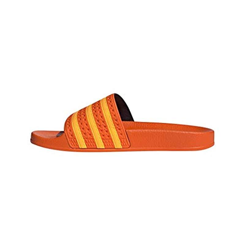 orange adidas flip flops